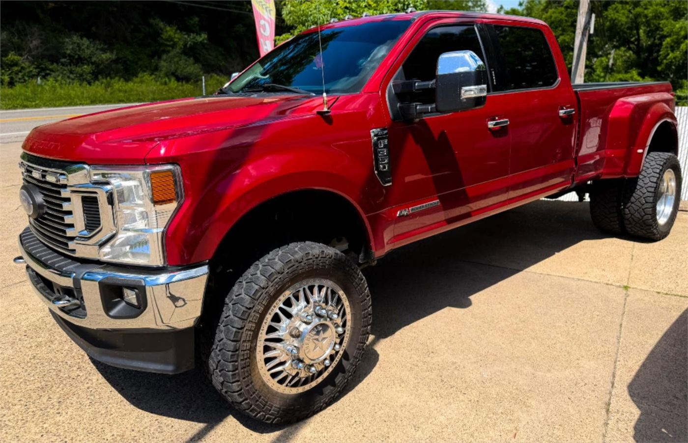 Detailed red truck with polished wheels outside RiverShine